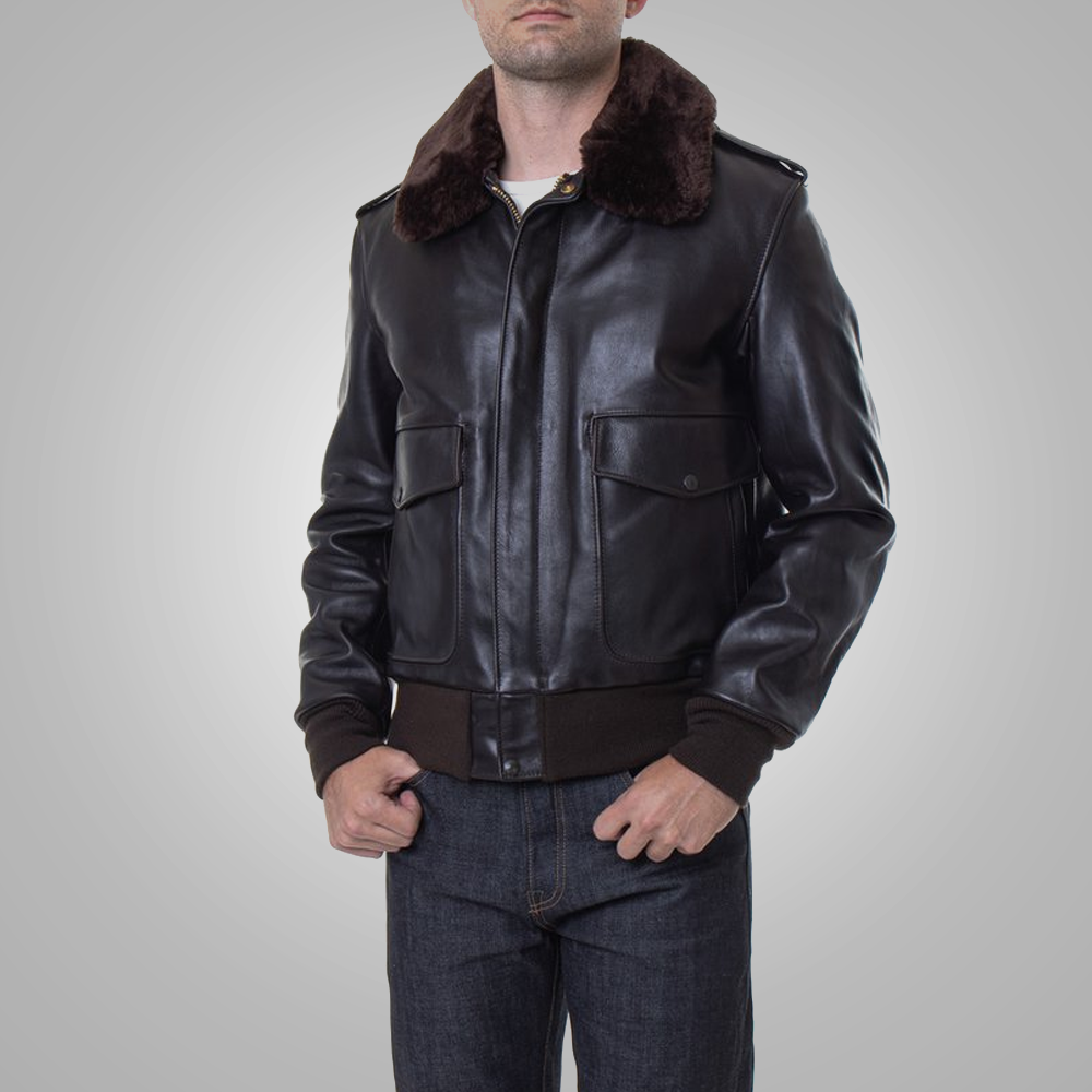 Man wearing a black leather jacket with brown fur collar on a gray background
