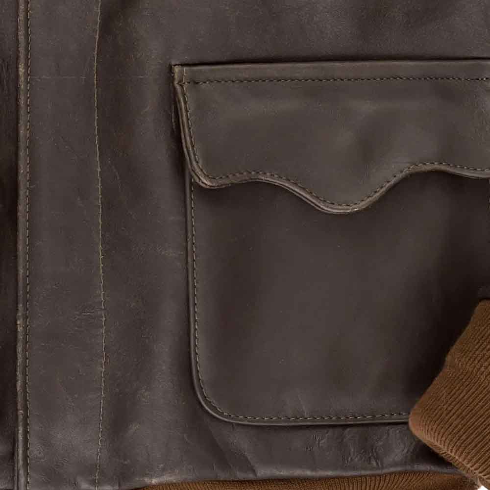 Close-up of a brown leather jacket with a pocket