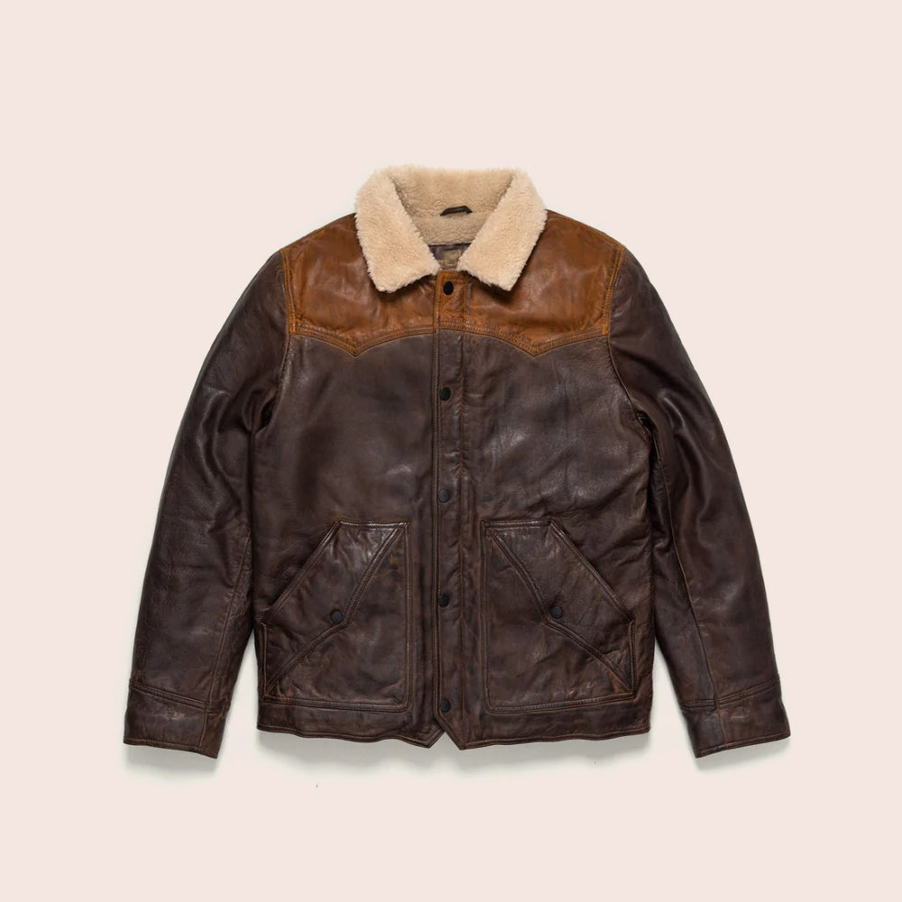 Brown leather jacket with beige shearling collar on a beige background