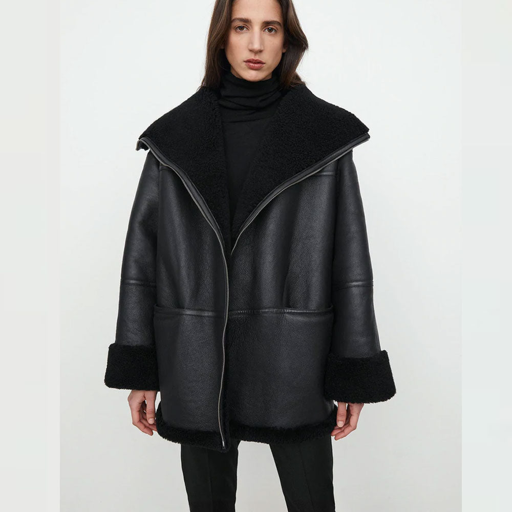 Woman wearing a black leather coat with a white background