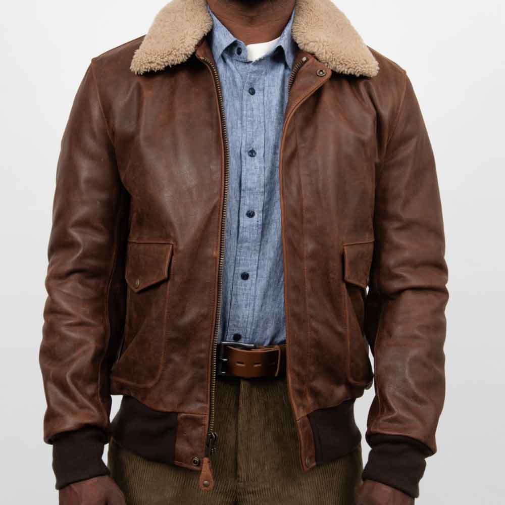 Brown leather jacket with fur collar worn by a person on a white background
