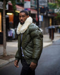  A person wearing Green V bomber leather jacket with fox fur collar in off white colour