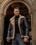 Man wearing a leather jacket with fur lining standing in an archway.